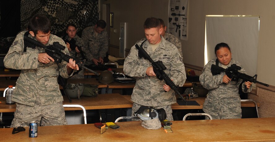 Combat Arms students practice weapon positioning during the classroom portion of the new Rifle/Carbine Air Force Qualification Course at Barksdale Air Force Base, La., Aug. 8, 2012. The 2nd Security Forces Squadron here recently revamped the riffle qualification course to align with new Air Force standards and ensure Barksdale Airmen preparing to deploy have all the training necessary to protect themselves and others. (U.S. Air Force photo/Senior Airman Sean Martin) (RELEASED)