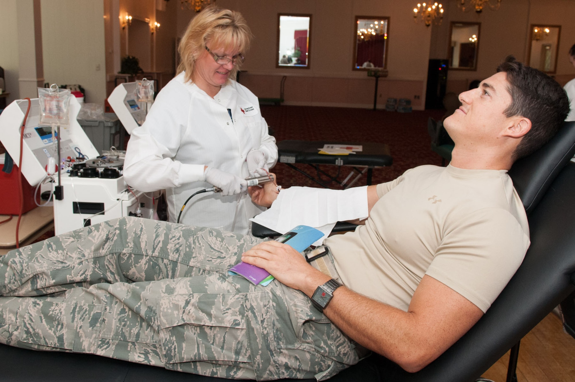 HANSCOM AIR FORCE BASE, Mass. – Terri Duggen, from the Red Cross, draws double red cells from Capt. Nathan Terrazone on Aug. 7 at the Minuteman Commons. Members from the Hanscom community came to help fill a critical blood supply need during the Red Cross blood drive. (U.S. Air Force photo by Rick Berry)