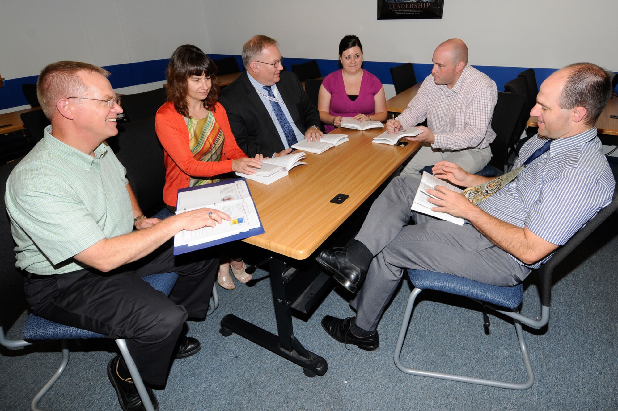 HANSCOM AIR FORCE BASE, Mass. – Air Command and Staff College seminar participants (left to right) Herb Grover, Diane McElligott, Alan Galster, Sarah Olaciregui, Wade Johnson and Brian Smith (not pictured: Capt. Joe Clancy) discuss course material at the Education and Training Center Aug. 2. The seminar formed in September 2011 and members completed the professional military education course in the last few weeks. (U.S. Air Force photo by Linda LaBonte Britt) 