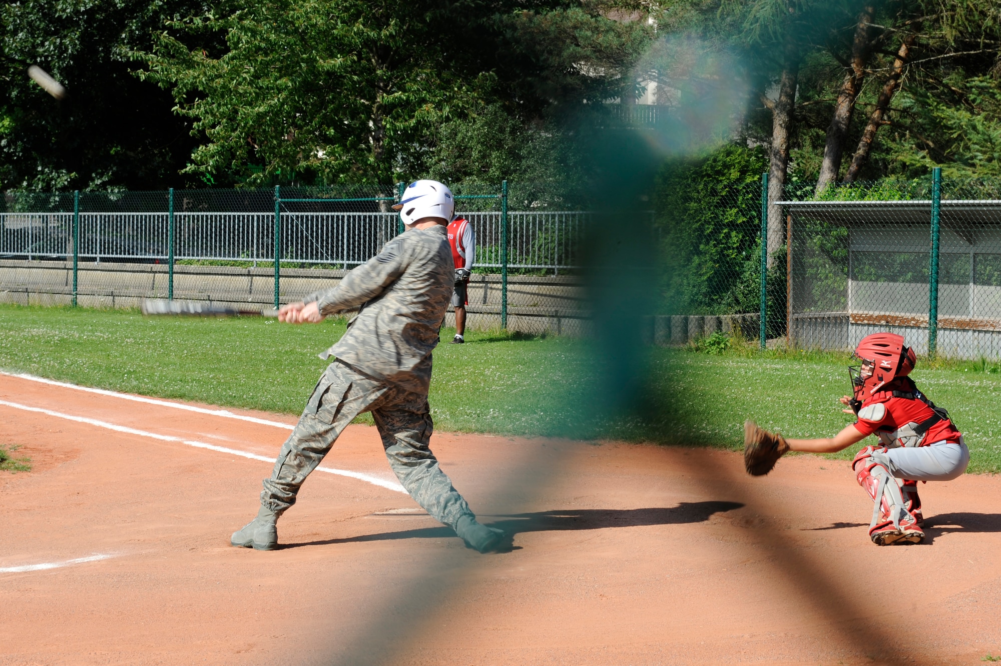 Chief Master Sgt. Craig A. Adams, 3rd Air Force command chief, goes to bat with athletes from the KMC all stars before practice at Donnelly Park on Ramstein Air Base, Aug. 7, 2011. For the third time in four years, the KMC all stars advanced to the Little League World Series beginning Aug. 16 in Williamsport, Penn. (U.S. Air force photo/ Senior Airman Aaron-Forrest Wainwright)