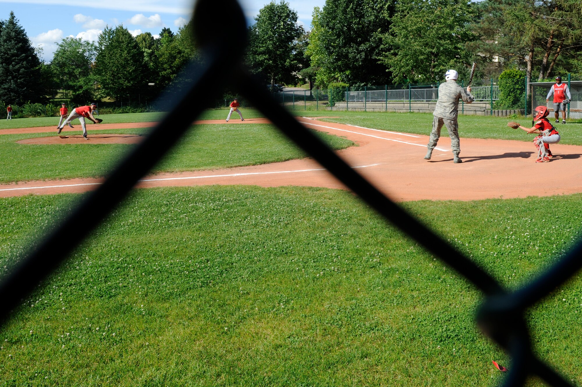 Chief Master Sgt. Craig A. Adams, 3rd Air Force command chief, goes to bat with athletes from the KMC all stars before practice at Donnelly Park on Ramstein Air Base, Aug. 7, 2011. For the third time in four years, the KMC all stars advanced to the Little League World Series beginning Aug. 16 in Williamsport, Penn. (U.S. Air force photo/ Senior Airman Aaron-Forrest Wainwright)