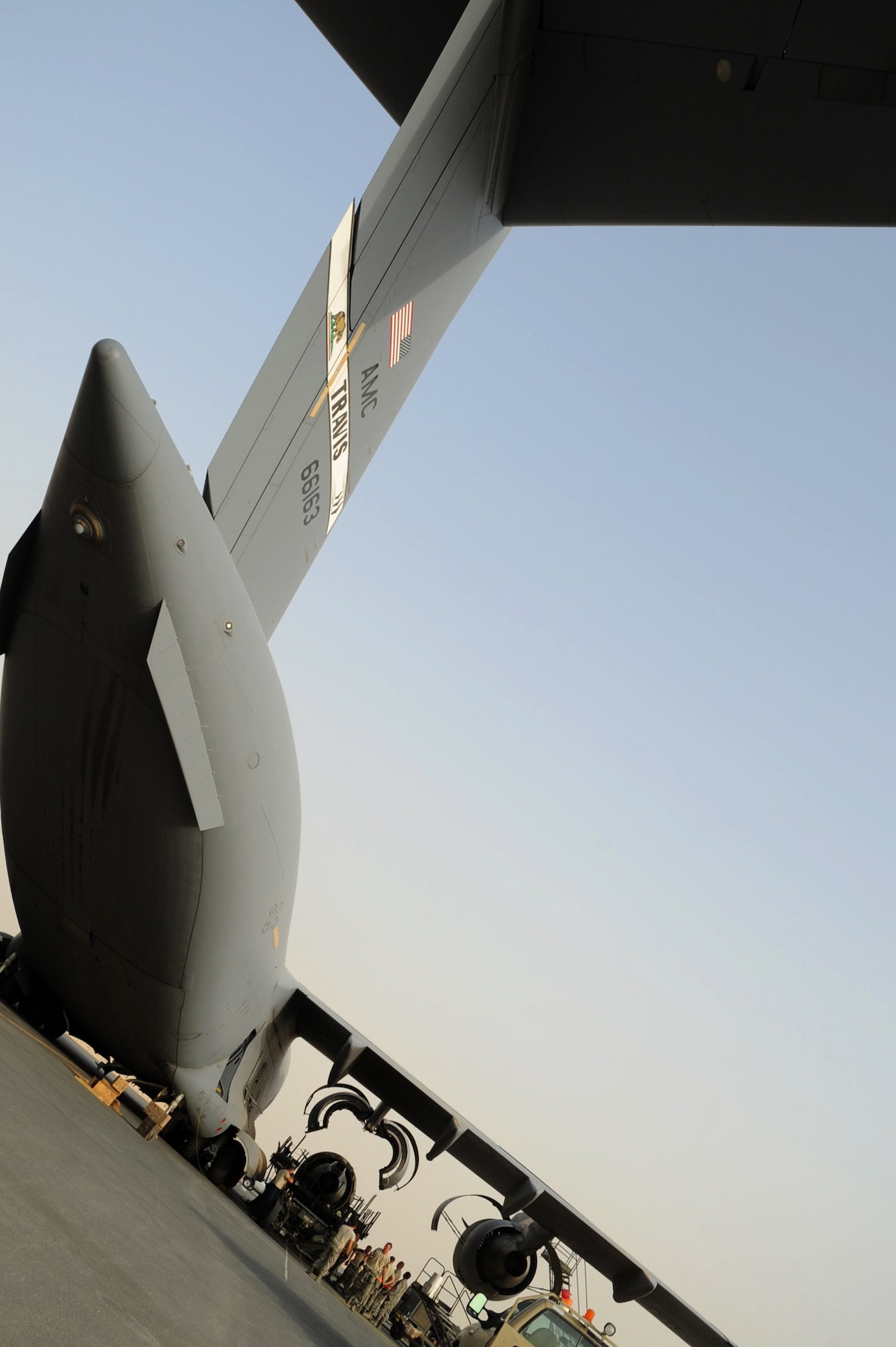 Members from the 8th Expeditionary Air Mobility Squadron slowly lower the C-17 Globemaster III engine in Southwest Asia, August 4, 2012. The engine change marks the first C-17 engine change in more than a year here at the 379th Air Expeditionary Wing. Airmen from the ?Ocho? team finished in 34 hours and saved $120,000 by doing the repairs downrange while a typical engine change back home are done within 48 hours in a controlled environment inside an aircraft hangar. (U.S. Air Force photo/Staff Sgt. Sheila deVera)