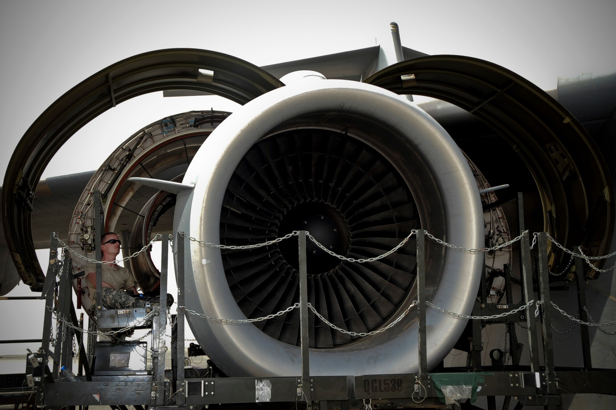 U.S. Air Force Staff Sgt. Robert Hill, 8th Expeditionary Air Mobility Squadron guidance and control craftsman, takes a break underneath the C-17 Globemaster III outboard engine cowl in Southwest Asia, August 4, 2012. Most engine changes are done within 48 hours in a controlled environment inside an aircraft hangar, but the ?Ocho? team finished in 34 hours and saved $120,000 by doing the repairs downrange at the 379th Air Expeditionary Wing. Hill is deployed from Joint Base Lewis-McChord, Wash., and is a native of Parkton, N.C. (U.S. Air Force photo/Staff Sgt. Sheila deVera)