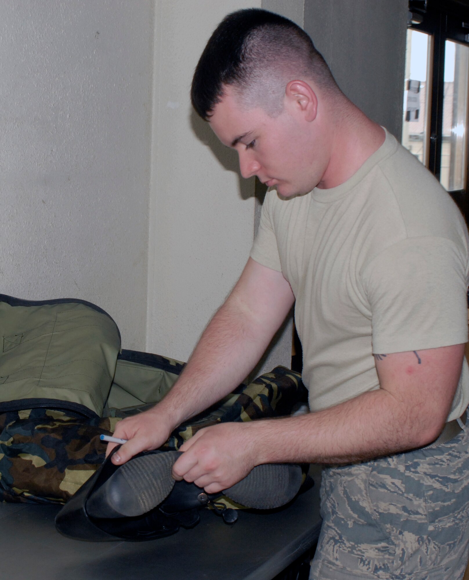 Senior Airman Nathan Firklay, 51st Logistics Readiness Squadron Individual Protective Equipment journeyman, checks returned equipment at Osan Air Base, Republic of Korea, Aug. 9, 2012. All items are inspected when issued and returned to ensure that no gear will expire during an Airman’s time here. (U.S. Air Force photo/Airman 1st Class Alexis Siekert)