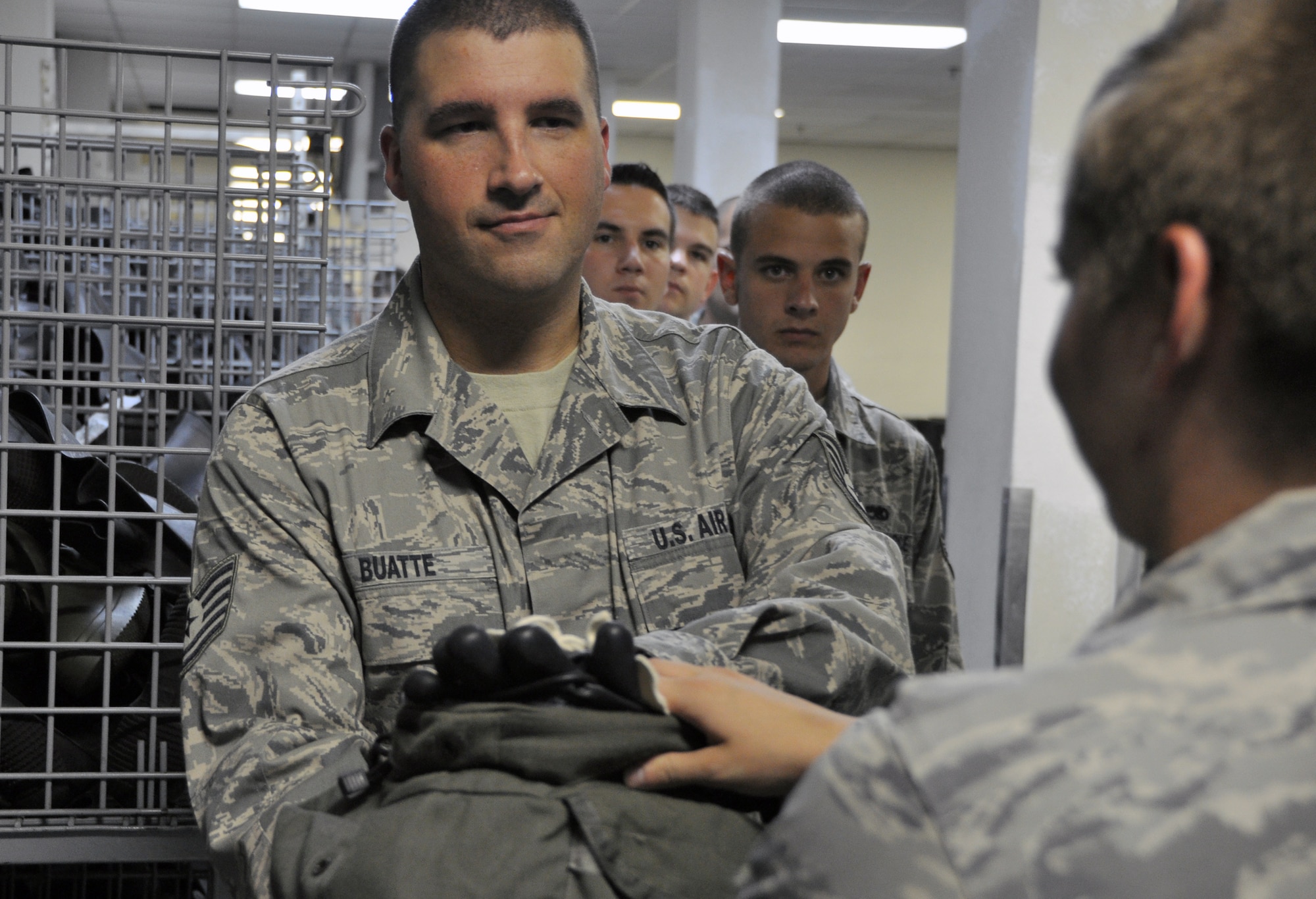 Tech. Sgt. Michel Buatte, 6th Intelligence Squadron, receives his gas mask and gloves at the 51st Logistics Readiness Squadron Individual Protective Equipment facility during combat in-processing at Osan Air Base, Republic of Korea, Aug. 7, 2012. The facility’s 19-person team issues IPE gear to Osan personnel as well as Airmen at geographically seperated units in the Republic of Korea. (U.S. Air Force photo/Airman 1st Class Alexis Siekert)