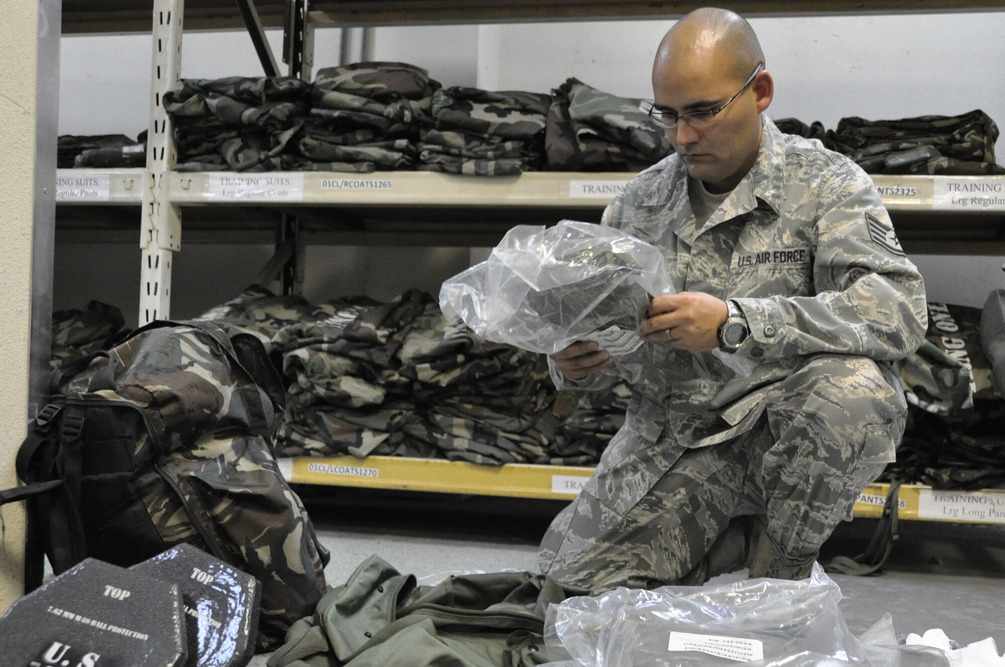 Staff Sgt. Daniel De La Torre, packs his Individual Protective Equipment during combat inprocessing at Osan Air Base, Republic of Korea, Aug. 7, 2012. All service members in-processing Osan must visit the 51st Logistics Readiness Squadron IPE facility to be issued exercise and real world gear.  De La Torre is a 51st Aerospace Medicine Squadron medical technician. (U.S. Air Force photo/Airman 1st Class Alexis Siekert)