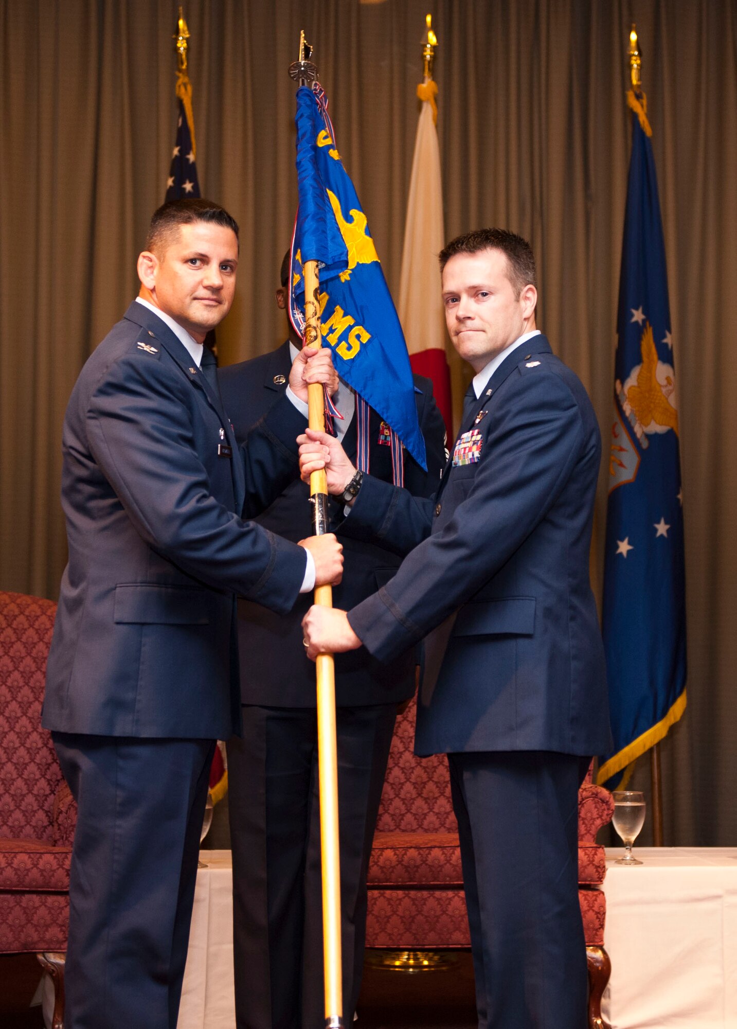 YOKOTA AIR BASE, Japan -- Col. Kenneth Brownell, 515th Air Mobility Operations Group commander, passes the730th Air Mobility Squadron guidon to Lt. Col Brett Sowell, incoming commander for the 730 AMS, at Yokota Air Base, Japan, Aug. 9, 2012. This will be Sowell's first squadron command position. (U.S. Air Force photo by Airman 1st Class Krystal M. Garrett) 