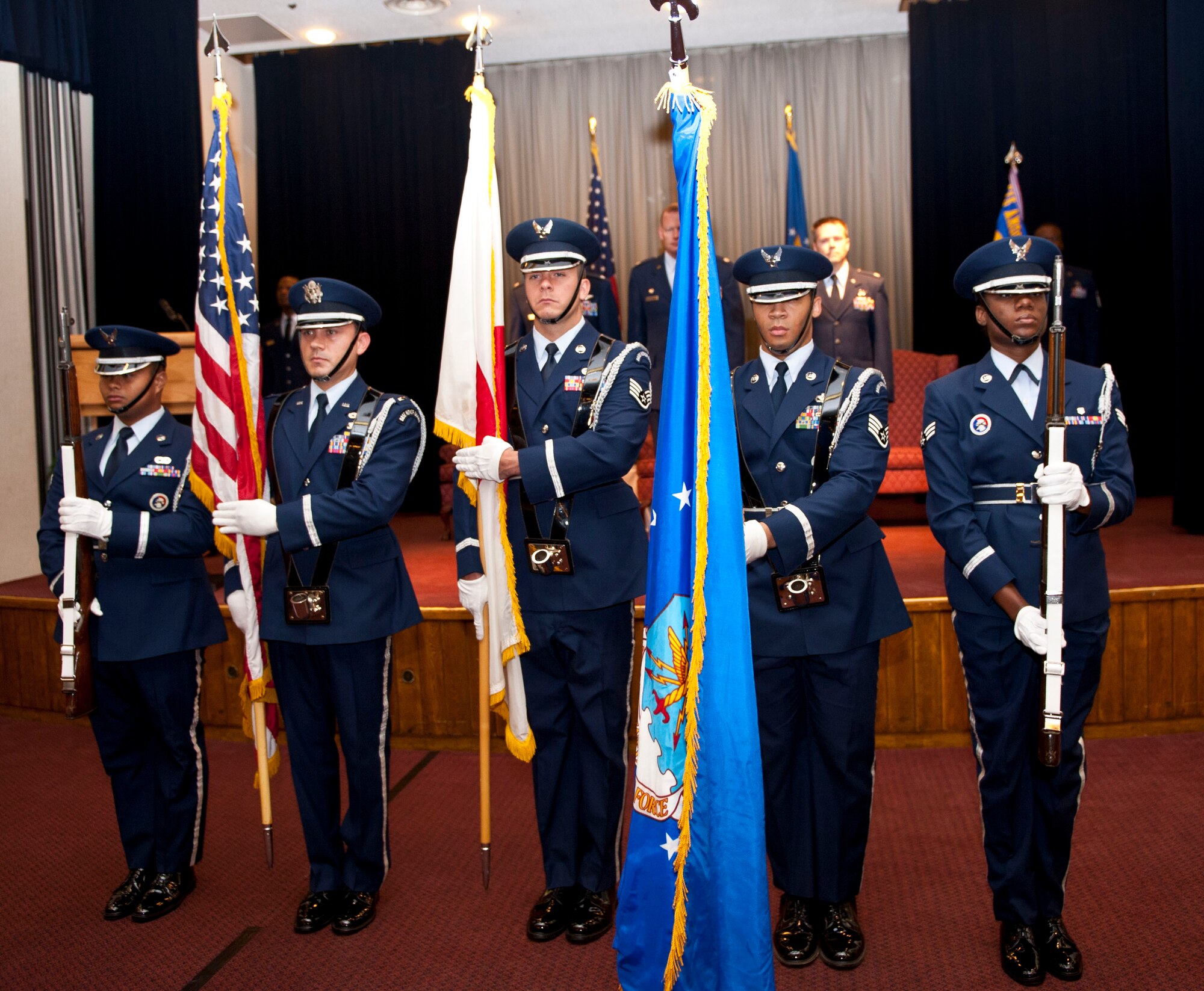 YOKOTA AIR BASE, Japan -- Members of the Yokota Honor Guard present the U.S., Japanese and Air Force flags during the 730th Air Mobility Squadron change of command at Yokota Air Base, Japan, Aug. 9, 2012. U.S. change of command ceremonies are a tradition dating back to the Colonial Army when units watched the control pass from one commander to the next. (U.S. Air Force photo by Airman 1st Class Krystal M. Garrett) 