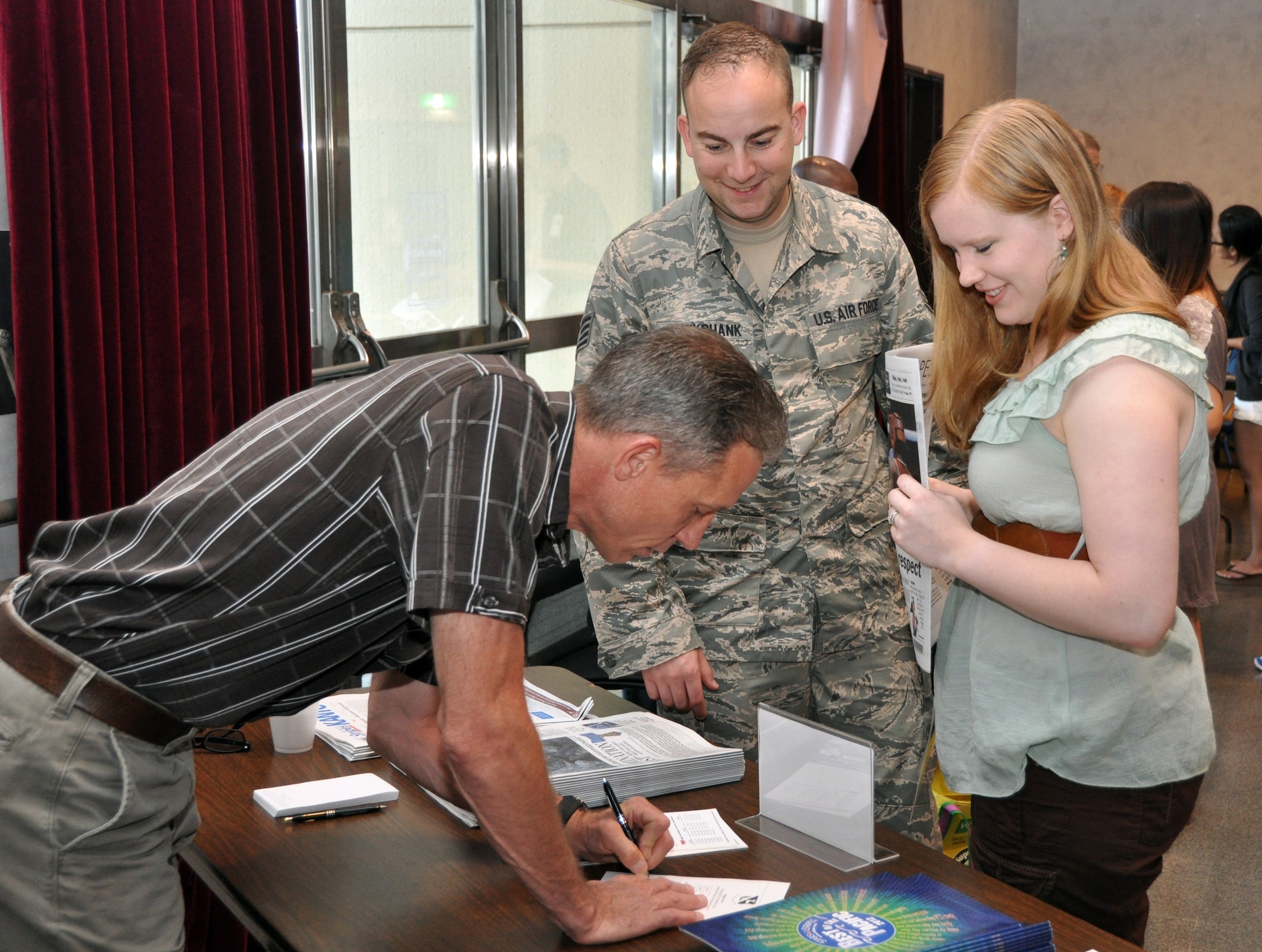 YOKOTA AIR BASE, Japan -- Staff Sgt. Michael Cruikshank, center, and wife Mienke, right, sign up for a subscription to Stars and Stripes during the information fair on the second day of Right Start, Aug. 9, 2012 at Yokota Air Base, Japan.  Stars and Stripes is one of more than 20 organizations from around the base that participate in the information fair. (U.S. Air Force photo by Senior Airman Katrina R. Menchaca)