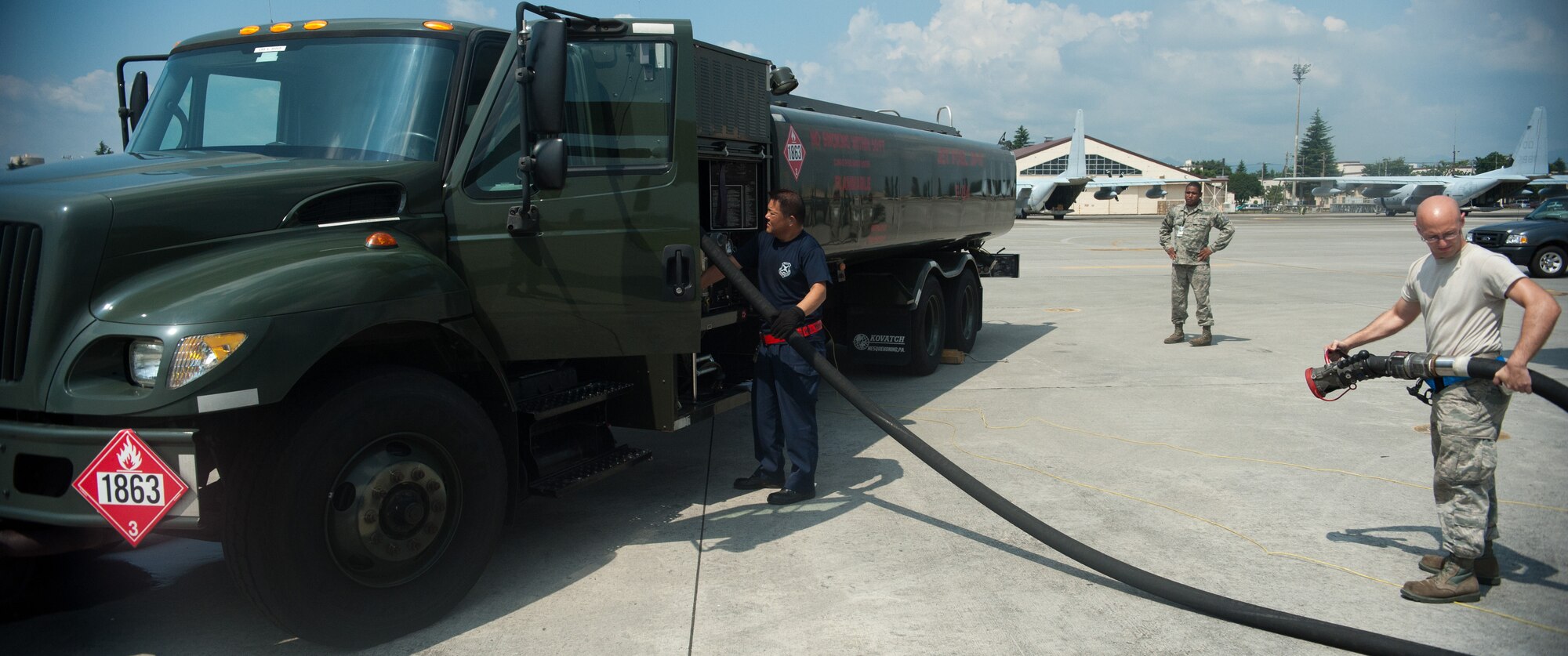 YOKOTA AIR BASE, Japan -- Members from the 374th Aircraft Maintenance Squadron and 374th Logistics Readiness Squadron pack a fuel hose at Yokota Air Base, Japan, on Aug. 7, 2012. The 374 LRS Petroleum, Oils and Lubricants shop handles all fuel related requests and mission requirements on base. (U.S. Air Force photo by Airman 1st Class John D. Partlow)