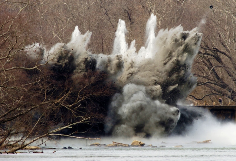 FREDERICKSBURG, Va. -- A controlled explosion breaches a section of Embrey Dam on Feb. 23, 2004 as part of the dam's removal process. The 94 year old dam no longer served a useful purpose and was removed to help restore the environment along the Rappahannock River. (U.S. Army file photo)   