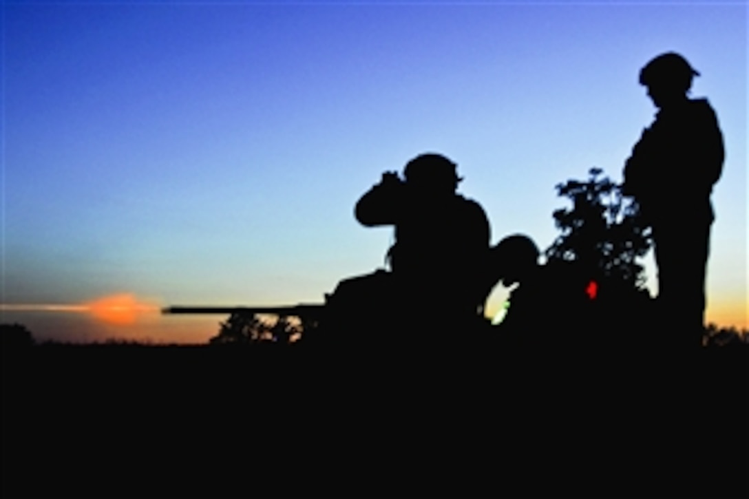 Soldiers and sailors fire a .50-caliber machine gun during night weapons qualifications as part of pre-deployment training on Camp Atterbury, Ind., Aug. 6, 2012. Ten provincial reconstruction teams are preparing for duty in Afghanistan to support security, governance and socioeconomic development.