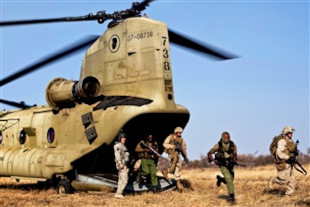 U.S. Marines and Botswana soldiers exit a CH-47F Chinook helicopter during Southern Accord 2012 at Thebephatshwa Air Base in Botswana, Aug. 3, 2012. The Marines are assigned to the 4th Marine Division's Delta Company, Anti-terrorism Battalion. The international exercise brings together U.S. and Botswana forces to foster security cooperation while conducting joint humanitarian assistance, peacekeeping operations and aeromedical evacuation exercises.