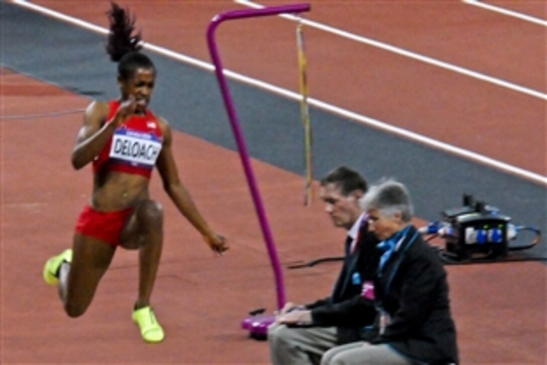 Janay DeLoach, daughter of retired Air Force Chief Master Sgt. William DeLoach, soars through the air in her third attempt at the women's long jump final at Olympic Stadium in London, Aug. 8, 2012. DeLoach received the bronze medal for her effort.