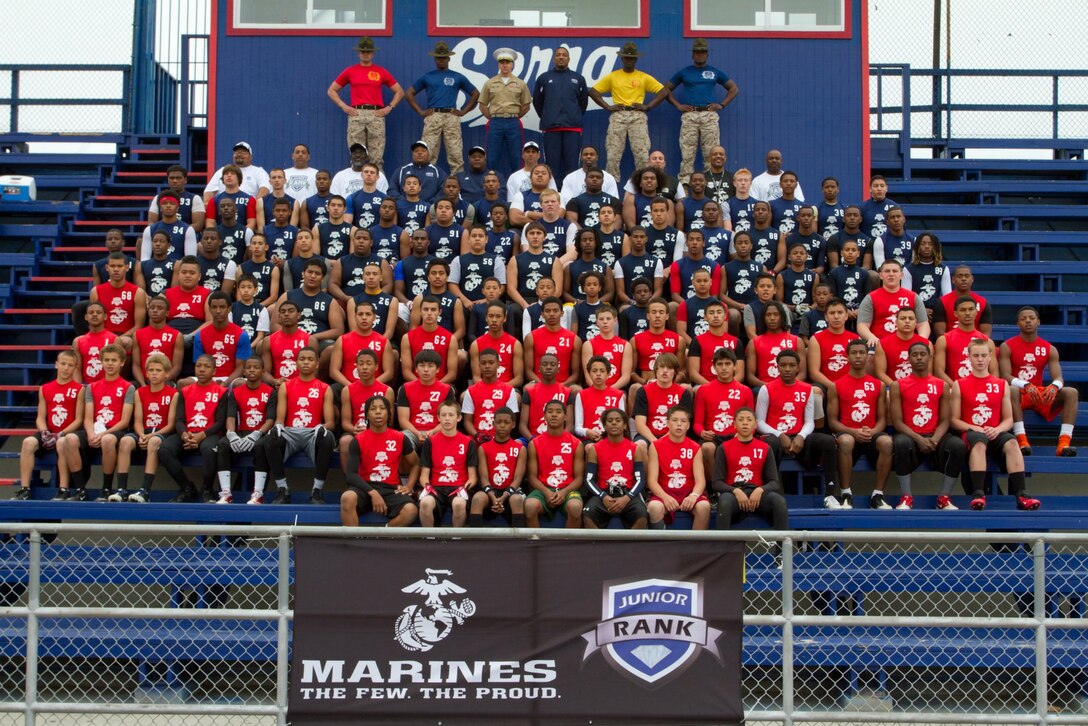 Drill instructors, players and coaches pose for a team picture at the Junior Rank Diamond Flight football camp in Gardena, Calif., April 1. Junior Rank will be partnering with Marine Corps Recruiting Command once again for the 2013 Semper Fidelis All-American Bowl in Carson, Calif., Jan. 4, 2012. (US Marine Corps photo by Sgt. Michael Darnell)