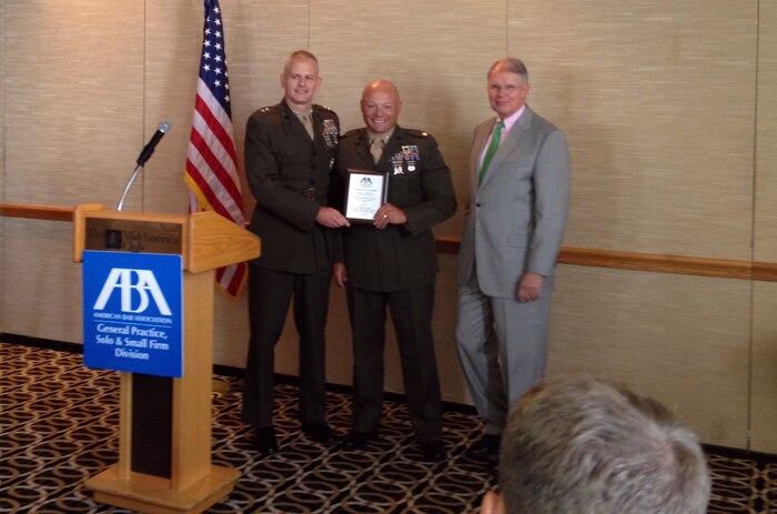 Lt. Col. Robert G. Bracknell (middle), the staff judge advocate with 2nd Marine Logistics Group, poses for a picture with his award after a ceremony in Chicago, Aug. 3, 2012.  Bracknell received the American Bar Association’s 2012 ABA Outstanding Military Service Career Judge Advocate Award. (Courtesy Photo)