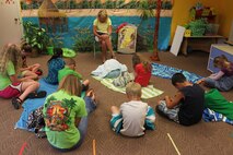 Barbara Taylor, volunteer from First Baptist Church of Friendsville, Tenn., leads Vacation Bible School participants in prayer at the Marine Corps Air Station New River, N.C., Chapel Annex, July 18. Volunteers held VBS for children of air station Marines at the air station chapel, July 16-19. 