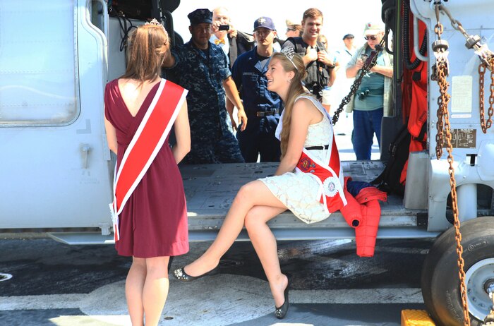 Alexandra Dienesch-Calamari, the 2012 Sea Goddess for Maine’s Lobster Festival in Rockland, sits in the bay of an MH60 Sierra Night Hawk helicopter tied down on the USS San Antonio’s flight deck, Aug. 3. She and other visitors to the ship were able to interact with the Marines and sailors aboard the vessel during tours of the San Antonio. (Photo by Lance Cpl. Paul Peterson)