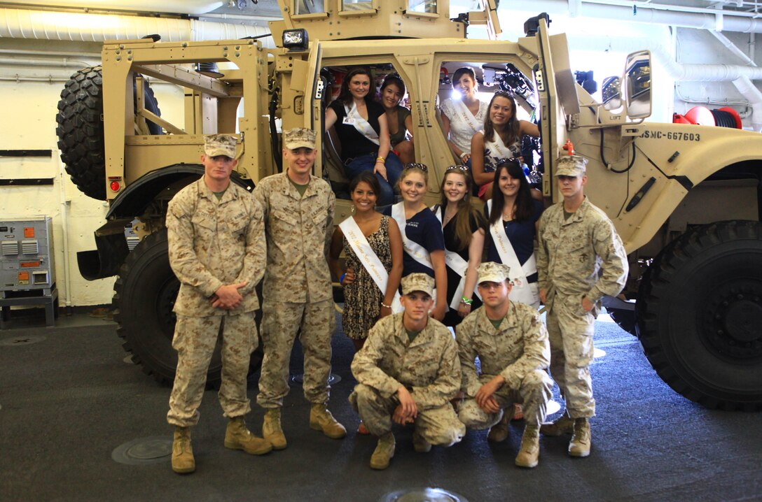 The 2012 Sea Princesses, who took part in Maine’s Lobster Festival beauty pageant in Rockland, gather in front of a Mine Resistant Ambush Protected – All Terrain Vehicle aboard the USS San Antonio, Aug 3. The ship anchored in the bay to provide support for the festival and demonstrate its capabilities to the American public. The Marines and sailors aboard the vessel joined in the festivities on shore, Aug. 1-5. (Photo by Lance Cpl. Paul Peterson)