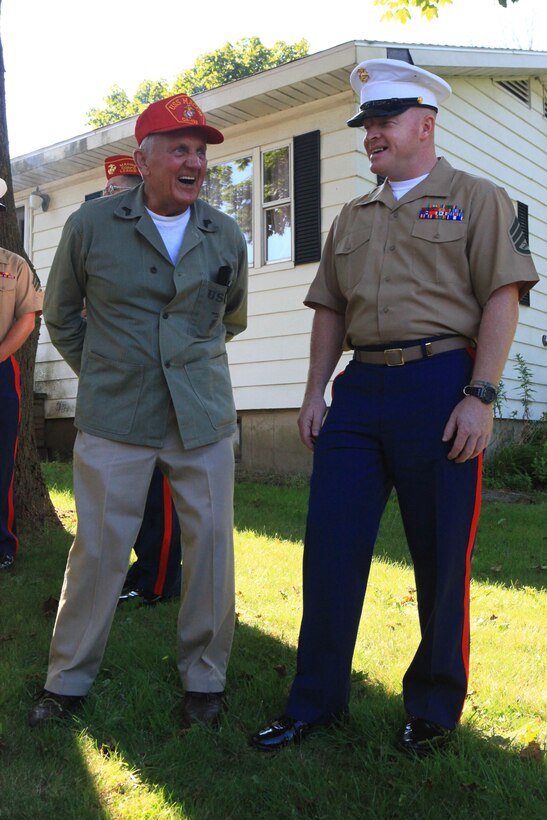 Staff Sgt. Wesley Carpenter, a motor transport operations chief with Combat Logistics Regiment 2, 2nd Marine Logistics Group, speaks with Douglas Miller, a retired Marine Corps veteran who served with the 6th Fleet in the 1950s, prior to marching in the parade for Maine’s 2012 Lobster Festival in Rockland, Aug. 4. Carpenter helped organize the Marines for the festival. (Photo by Lance Cpl. Paul Peterson)