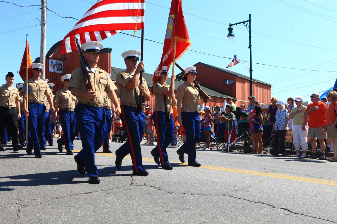 The Marine color guard for Maine’s 2012 Lobster Festival parade in Rockland passes a crowd of attendees, Aug. 4. Approximately 30 Marines and sailors from the 2nd Marine Logistics Group and 100 crewmembers of the USS San Antonio took part in the parade. (Photo by Lance Cpl. Paul Peterson)