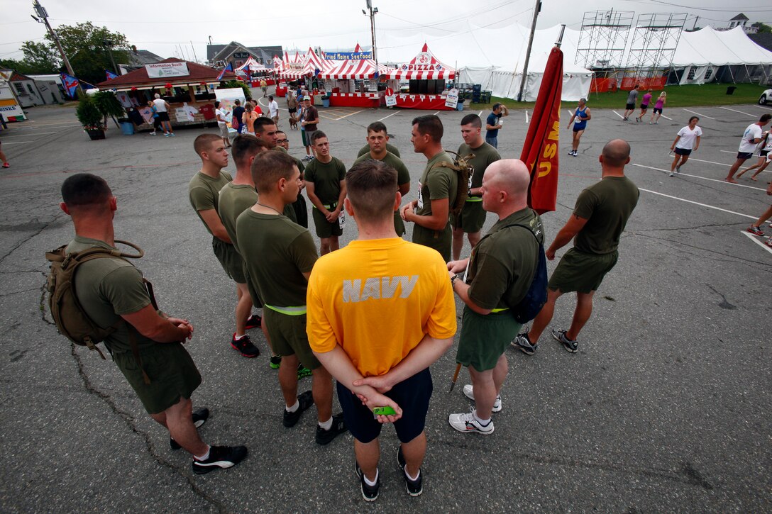Marines and sailors from 2nd Marine Logistics Group gather in Rockland for a 10-kilometer race during Maine’s 2012 Lobster Festival, Aug. 5, 2012. Each member of the team paid for their own entry, but they decided to begin the race as a group and sing cadence behind the other runners. (Photo by Lance Cpl. William M. Kresse)