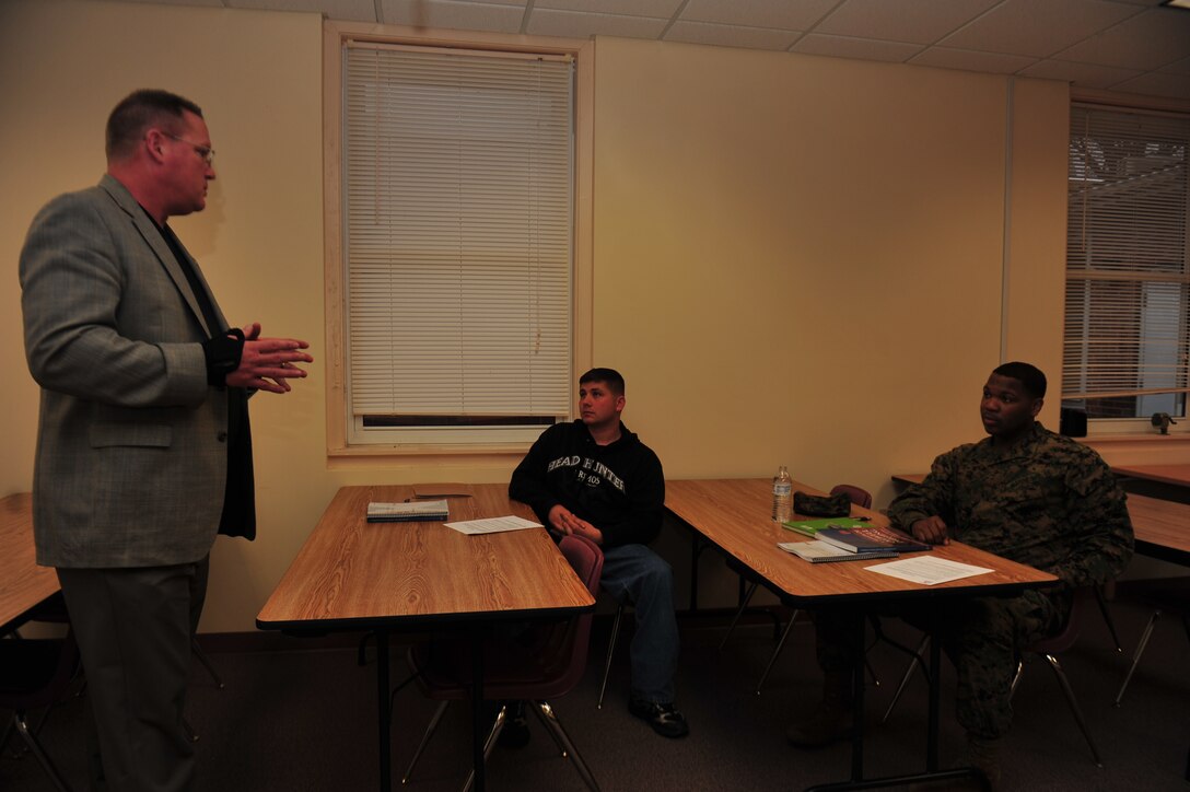 Troy Blank, vice president of admissions at Troop Transition, discusses the Troops 2 Roughnecks course with new students Sgt. Matthew Smith, with The Basic School's safety division, and Sgt. Caleb King, an administrative clerk with Headquarters and Service Battalion, during the first class at the Lifelong Learning Education Center on March 9. Photo by Lance Cpl. Shandra Dyess