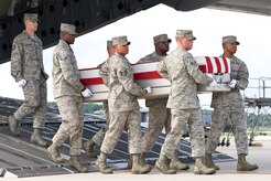 A U.S. Air Force carry team transfers the remains of Air Force Maj. Walter D. Gray, of Conyers, Ga., at Dover Air Force Base, Del., Aug. 10, 2012. Gray was assigned to the 13th Air Support Operations Squadron, Fort Carson, Colo. Tactical Air Control Party Airmen from the 13th Air Support Operations Squadron, Fort Carson, Colo., honored Gray, who was killed in Afghanistan last year, during a ruck march from Dover Air Force Base, Del., to Arlington National Cemetery, Aug. 4-8, 2013. (U.S. Air Force photo/Roland Balik)