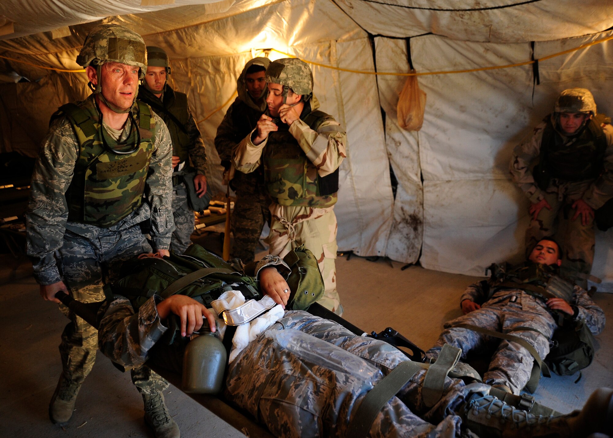 VANDENBERG AIR FORCE BASE, Calif. -- Maj. Christopher Black, a 30th Medical Operations Squadron flight surgeon, helps carry an injured airman on a stretcher as the medical personnel evacuate the wounded during a Northstar deployment exercise here Thursday, August 9, 2012. (U.S. Air Force photo/Michael Peterson)