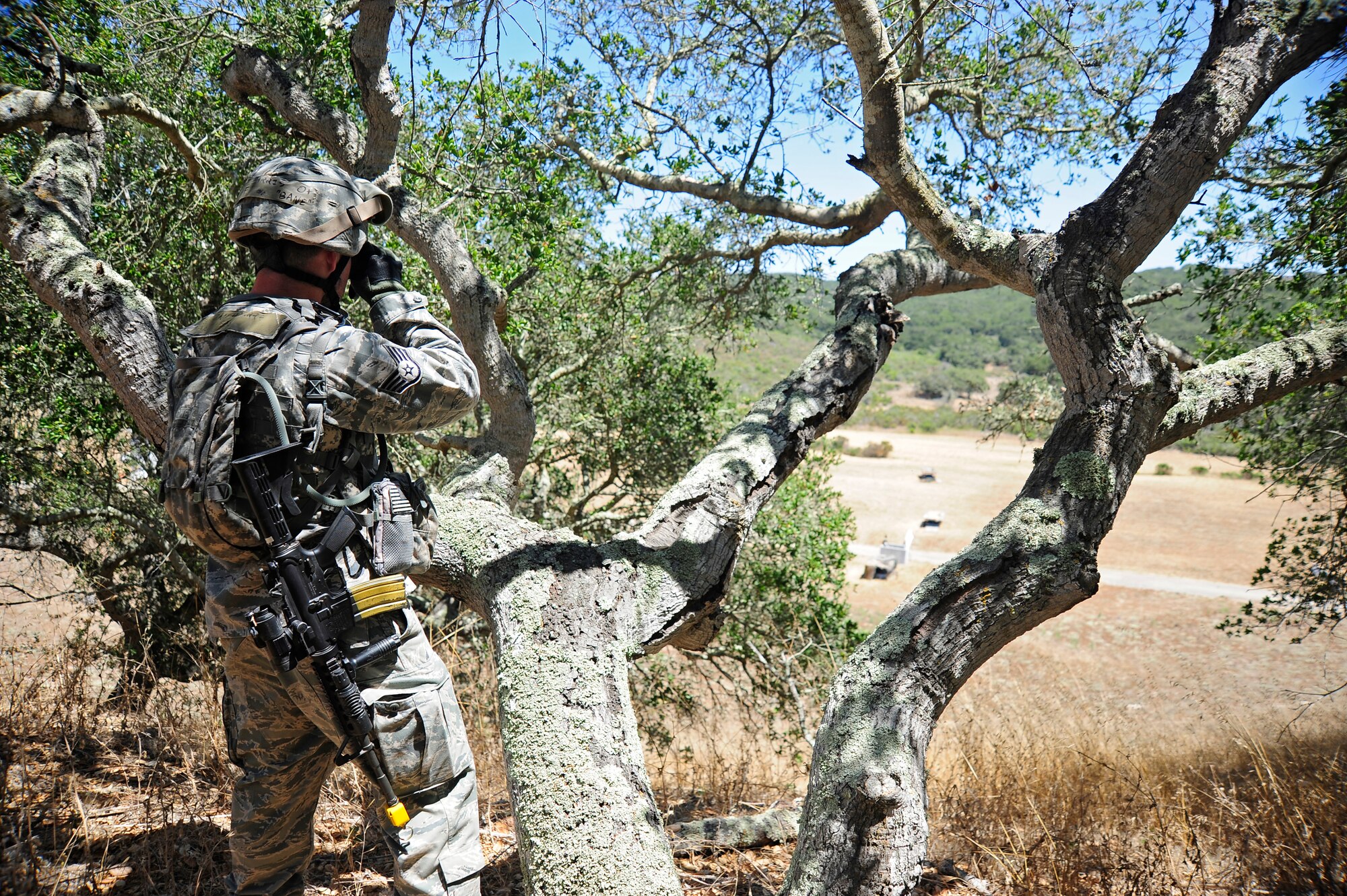 VANDENBERG AIR FORCE BASE, Calif. -- Staff Sgt. Sean Harris, a 30th Security Forces Squadron patrolman, watches for signs of enemy fighters and provides perimeter surveillance for the base's entry control point during a Northstar deployment exercise here Thursday, August 9, 2012. (U.S. Air Force photo/Michael Peterson)