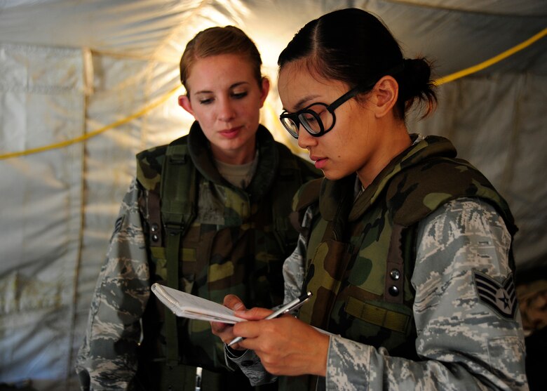VANDENBERG AIR FORCE BASE, Calif. -- Senior Airmen Courtney Joseph, a 30th Medical Operations Squadron medical technician, and Staff Sgt. Kristin Conde, a 30th Medical Support Squadron biomedical equipment technician, review checklist items and notes to ensure their medical tent is ready for operations during a Northstar deployment exercise Thursday, August 9, 2012. (U.S. Air Force photo/Michael Peterson)