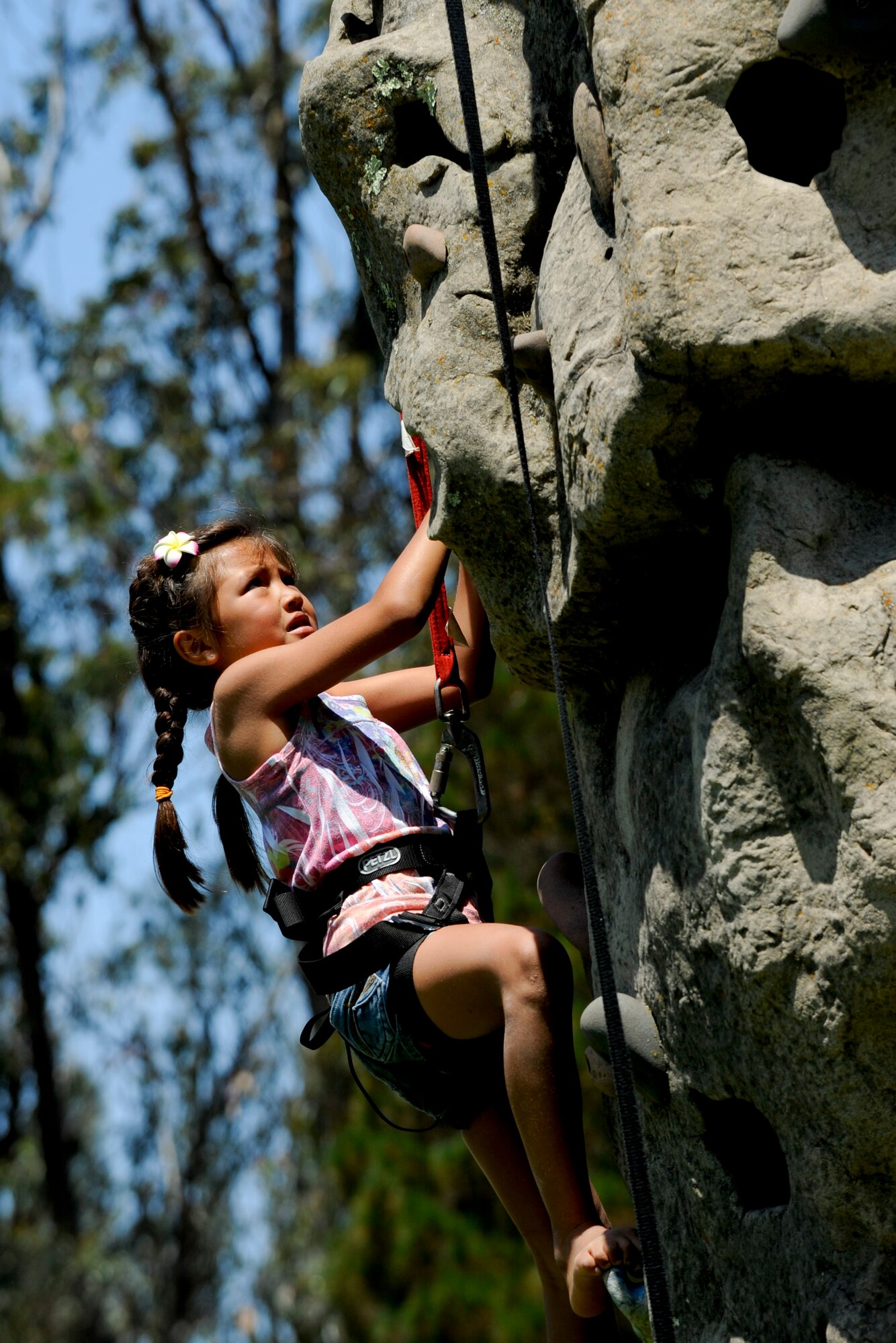 VANDENBERG AIR FORCE BASE, Calif. -- Alexandra Ontiveros, daughter of Staff Sgt. Mario Ontiverios, a 30th Security Forces Squadron conservation officer, and Michelle Ontiveros, climbs a rock wall during the 24th Annual Texas Blowout event at Cocheo Park here Friday, August 10, 2012. The 392d Training Squadron hosted the event to help support families and bring camaraderie to the Vandenberg community by providing attractions including a bounce house, a car show, pin the tail on the donkey and a cow pie tossing competition.  (U.S. Air Force photo/Staff Sgt. Levi Riendeau)
