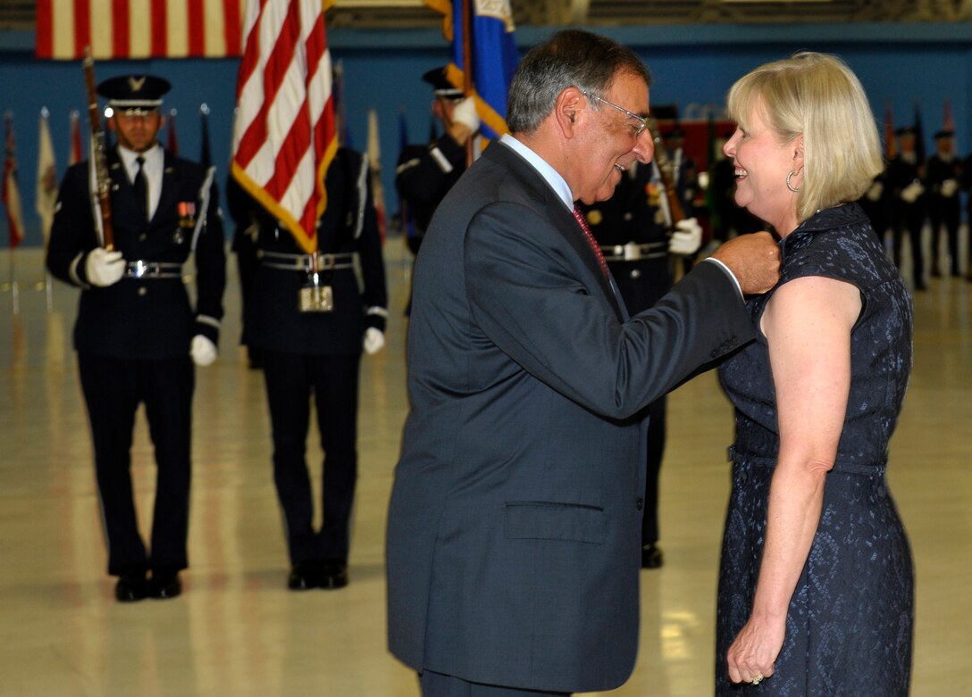 Secretary of Defense Leon Panetta awards Suzie Schwartz, wife of former Air Force Chief of Staff Gen. Norton Schwartz, with the Distinguished Public Service Award on the occasion of Schwartz's retirement during a ceremony at Joint Base Andrews, Md., Aug. 10, 2012.  Schwartz served as Air Force chief of staff for four years and was succeeded by Gen. Mark A. Welsh III.  Welsh previously commanded U.S. Air Forces in Europe.  (U.S. Air Force photo/Michael J. Pausic)