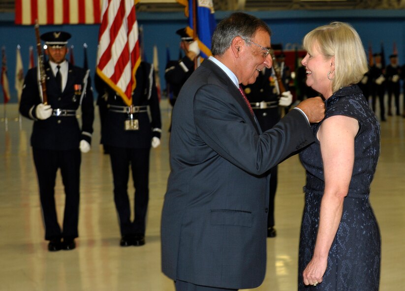 Secretary of Defense Leon Panetta awards Suzie Schwartz, wife of former Air Force Chief of Staff Gen. Norton Schwartz, with the Distinguished Public Service Award on the occasion of Schwartz's retirement during a ceremony at Joint Base Andrews, Md., Aug. 10, 2012.  Schwartz served as Air Force chief of staff for four years and was succeeded by Gen. Mark A. Welsh III.  Welsh previously commanded U.S. Air Forces in Europe.  (U.S. Air Force photo/Michael J. Pausic)
