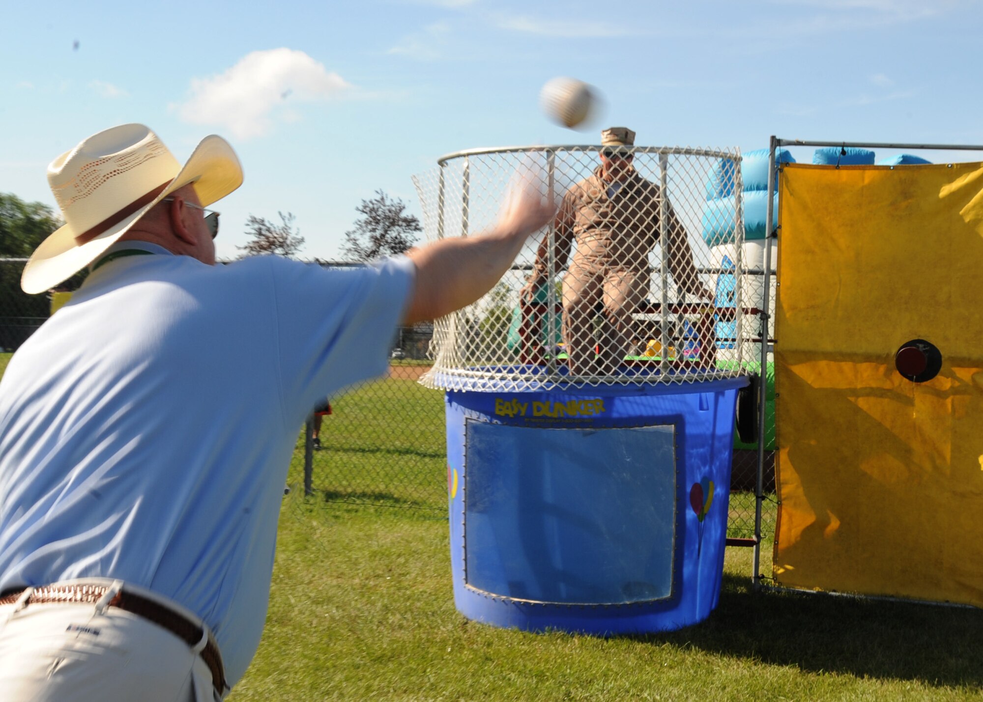 John Schuller of Northrop Grumman attempts to dunk Col. Tim Bush, 319th Air Base Wing commander, Aug. 9 during Summer Bash 2012 on Grand Forks Air Force Base, N.D. The 319th Operations Support Squadron placed first overall, with the 319th Civil Engineer Squadron placing second and the 69th Reconnaissance Group placing third. (U.S. Air Force photo/Senior Airman Amber Bennett)