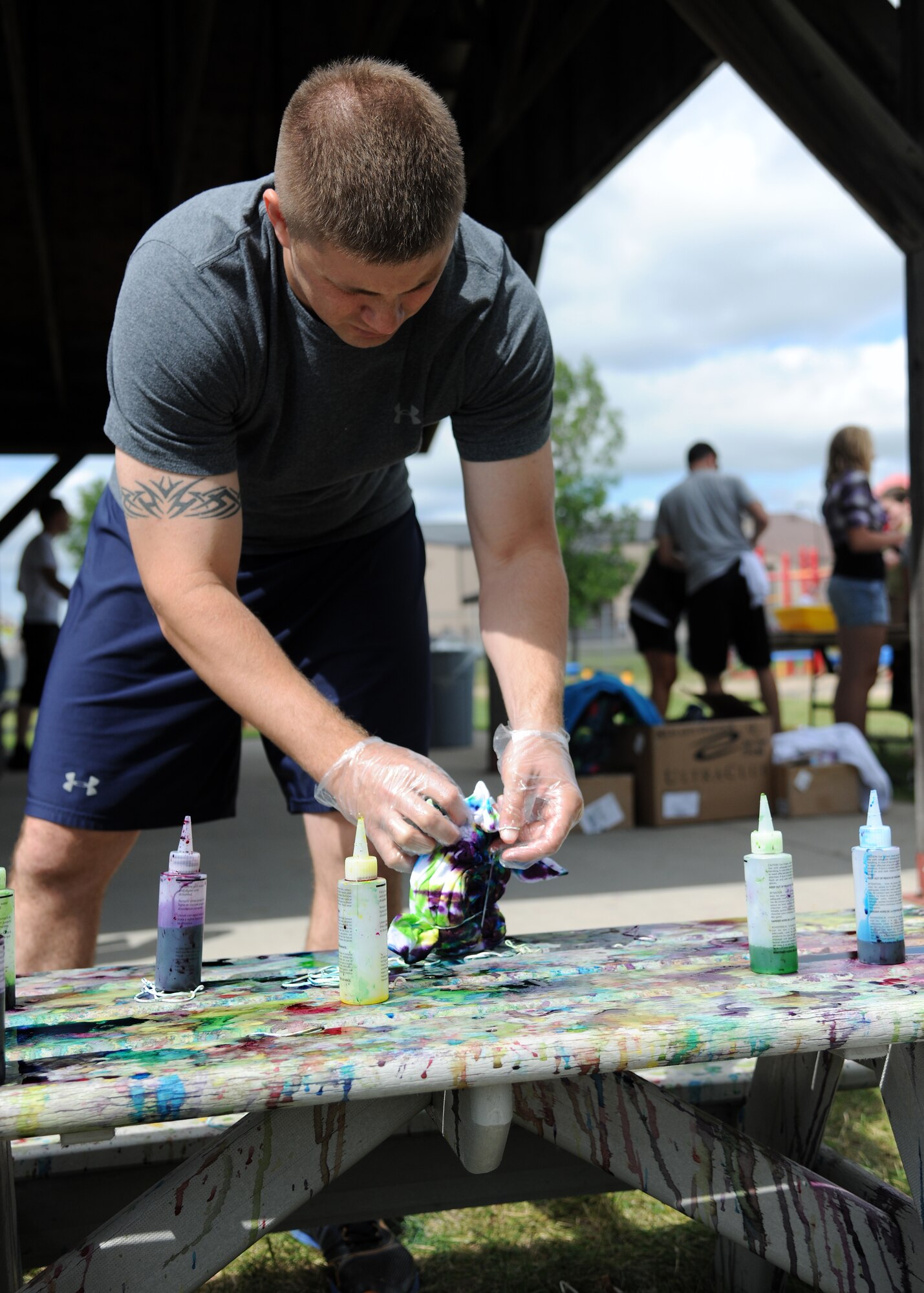 Master Sgt. Jason Gall, 319th Wing Staff Agencies superintendent, tie-dyes a t-shirt Aug. 9 during Summer Bash 2012, on Grand Forks Air Force Base, N.D. Summer Bash is an annual event designed to boost morale and increase esprit de corps. The 319th Operations Support Squadron placed first overall, with the 319th Civil Engineer Squadron placing second and the 69th Reconnaissance Group placing third. (U.S. Air Force photo/Airman 1st Class Ashley N. Taylor)