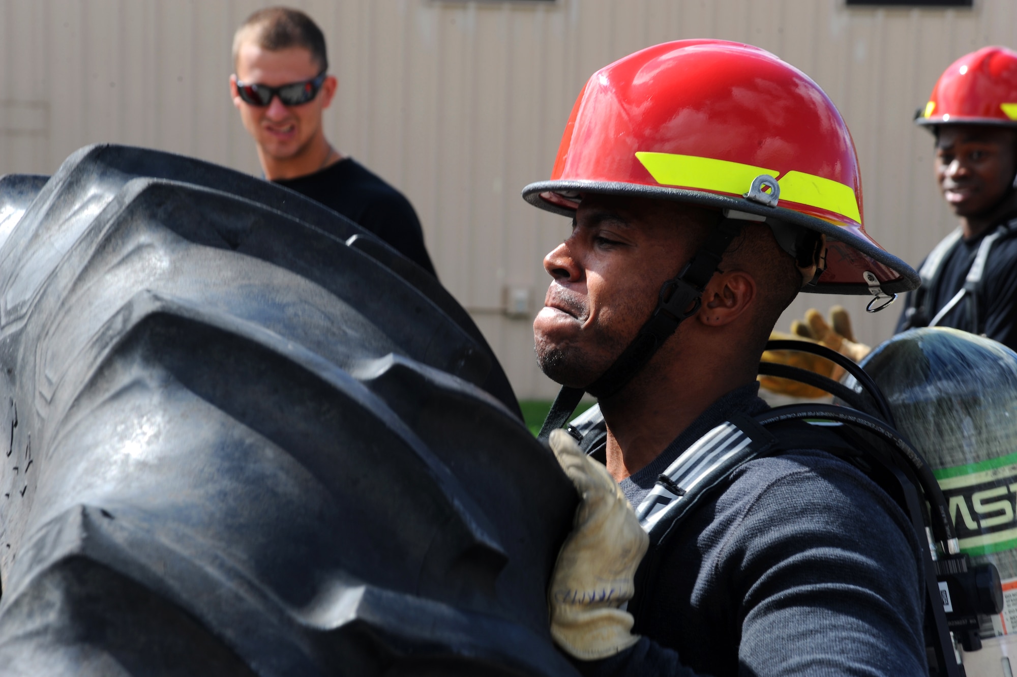 Senior Airman Tyler Acton, 319th Force Support Squadron, pushes a 280 pound tire during the Fireman’s Challenge Aug. 9 during Summer Bash 2012 on Grand Forks Air Force Base, N.D.  Summer Bash is an annual event designed to boost morale and increase esprit de corps. The 319th Operations Support Squadron placed first overall, with the 319th Civil Engineer Squadron placing second and the 69th Reconnaissance Group placing third. (U.S. Air Force photo/Airman 1st Class Xavier Navarro)