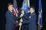 Brig. Gen. Theresa C. Carter, 502nd Air Base Wing and Joint Base San Antonio commander, passes the guidon to Col. Christine Erlewine, the new 902nd Mission Support Group commander, during the 902nd MSG change of command ceremony at JBSA-Randolph Aug. 10. 
(U.S. Air Force photo by Don Lindsey) 
