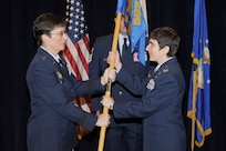 Brig. Gen. Theresa C. Carter, 502nd Air Base Wing and Joint Base San Antonio commander, passes the guidon to Col. Christine Erlewine, the new 902nd Mission Support Group commander, during the 902nd MSG change of command ceremony at JBSA-Randolph Aug. 10. 
(U.S. Air Force photo by Don Lindsey) 