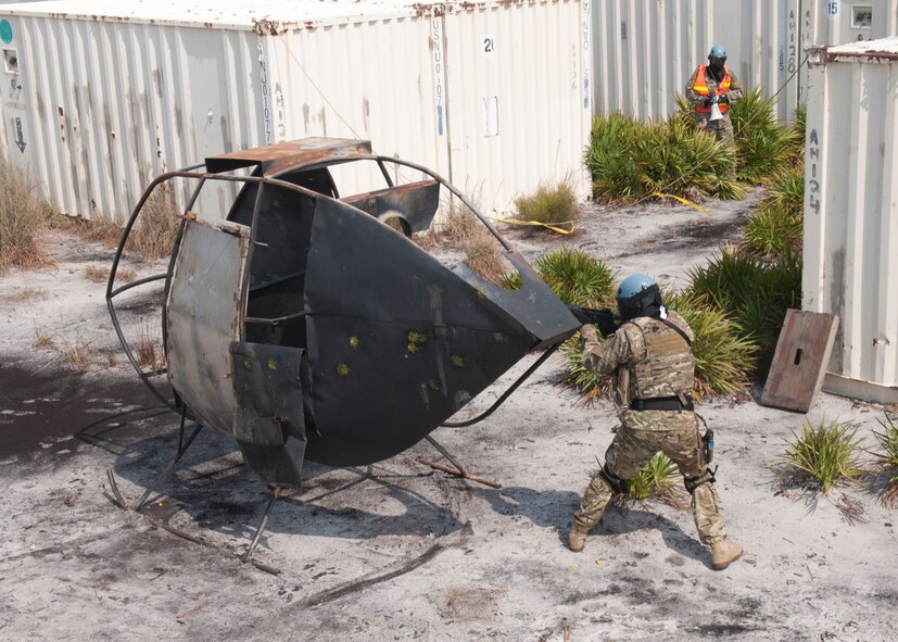 Airmen with the 347th Operations Support Squadron survival, evasion, resistance and escape specialists perform a live fire demonstration with simulation rounds for base leadership at the Grand Bay Bombing and Gunnery Range at Moody Air Force Base, Ga., Aug. 1, 2012. Some SERE training focuses on survival and evading but they also acquire skills such as building a fire, making a shelter and land navigation. (U.S. Air Force photo by Senior Airman Eileen Meier/Released)