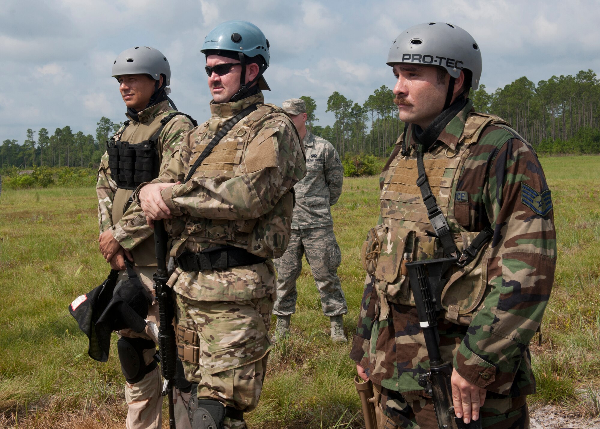 U.S. Air Force Tech. Sgt. Roong Burket, Master Sgt. Everett Barney and Staff Sgt. John Rosenberg, all survival, evasion, resistance and escape specialists from the 347th Operations Support Squadron, receive a safety briefing prior to performing a demonstration for base leadership at the Grand Bay Bombing and Gunnery Range at Moody Air Force Base, Ga., Aug. 1, 2012,. The SERE program provides military personnel and Department of Defense civilians with training on evading capture, survival skills and the military code of conduct. (U.S. Air Force photo by Senior Airman Eileen Meier/Released)