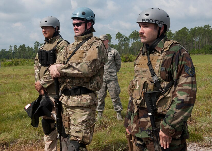 U.S. Air Force Tech. Sgt. Roong Burket, Master Sgt. Everett Barney and Staff Sgt. John Rosenberg, all survival, evasion, resistance and escape specialists from the 347th Operations Support Squadron, receive a safety briefing prior to performing a demonstration for base leadership at the Grand Bay Bombing and Gunnery Range at Moody Air Force Base, Ga., Aug. 1, 2012,. The SERE program provides military personnel and Department of Defense civilians with training on evading capture, survival skills and the military code of conduct. (U.S. Air Force photo by Senior Airman Eileen Meier/Released)