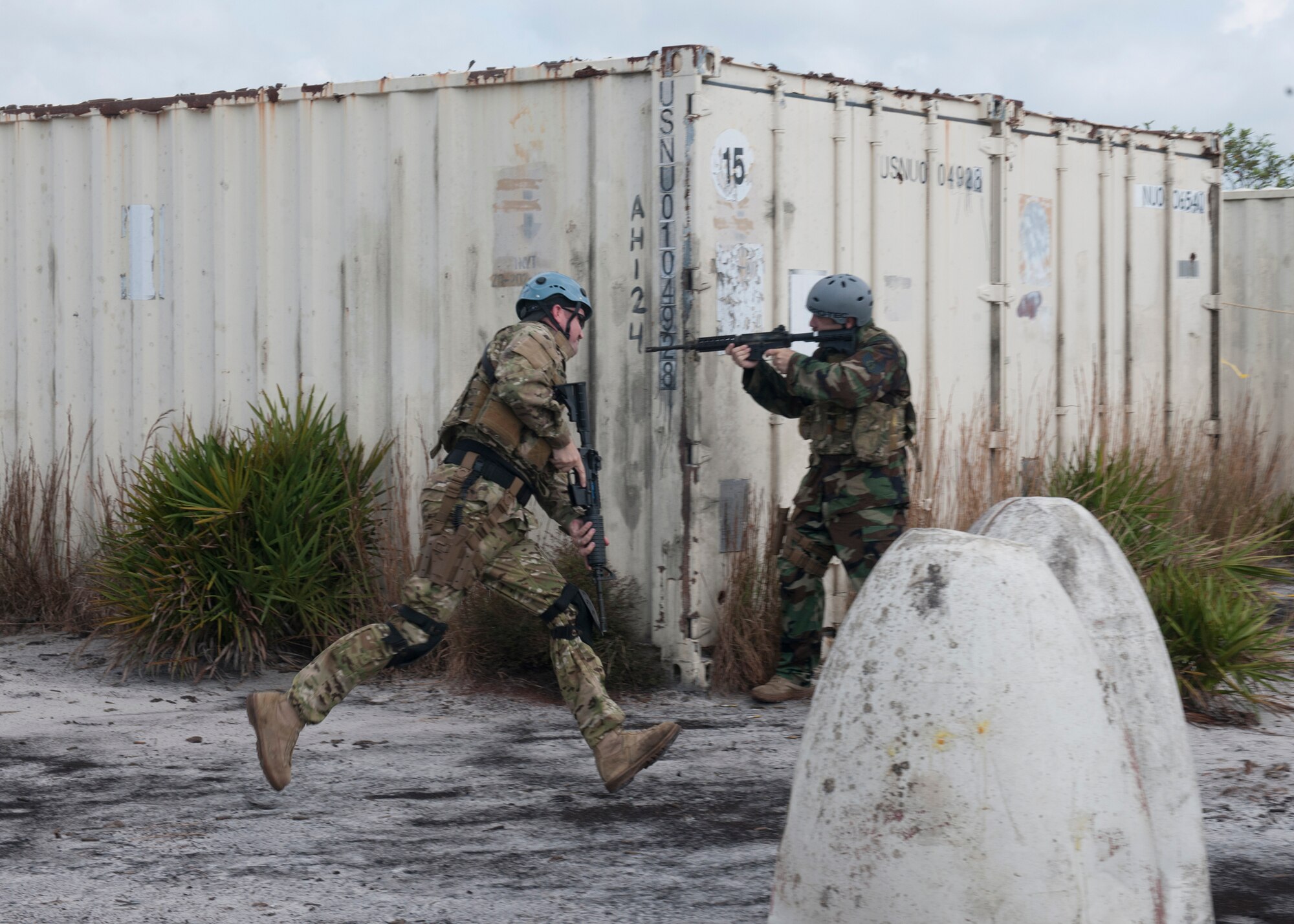 U.S. Air Force Master Sgt. Everett Barney and Staff Sgt. John Rosenberg, both survival, evasion, resistance and escape specialists from the 347th Operations Support Squadron, demonstrate how to respond to an enemy attack during a training session at the Grand Bay Bombing and Gunnery Range at Moody Air Force Base, Ga., Aug. 1, 2012. SERE specialists undergo intense training to learn survival skills on how to respond if they are attacked. (U.S. Air Force photo by Senior Airman Eileen Meier/Released)