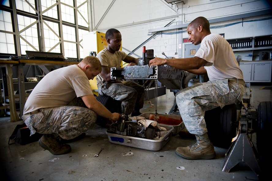 Airmen from the 2nd Maintenance Squadron Aerospace Ground Equipment flight rebuild the manipulator head of a bomb lift on Barksdale Air Force Base, La., Aug. 10. When functional, the bomb lift is used to move bombs into position under the B-52H Stratofortress so load team members can attach them to the aircraft. (U.S. Air Force photo/Staff Sgt. Chad Warren)(RELEASED)