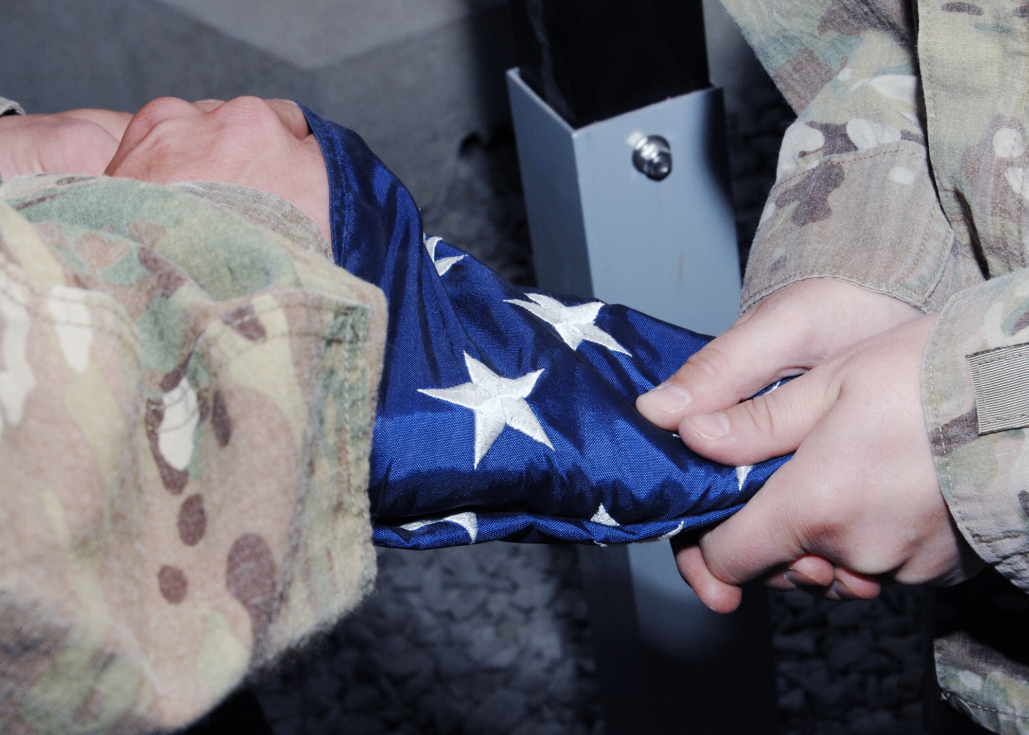 Airmen from the 651st Expeditionary Aeromedical Evacuation Squadron put the finishing touches on folding the U.S. flag during a retreat ceremony at Kandahar Airfield, Afghanistan,  Aug. 4, 2012. (U.S. Air Force photo/Master Sgt. Russell Martin)