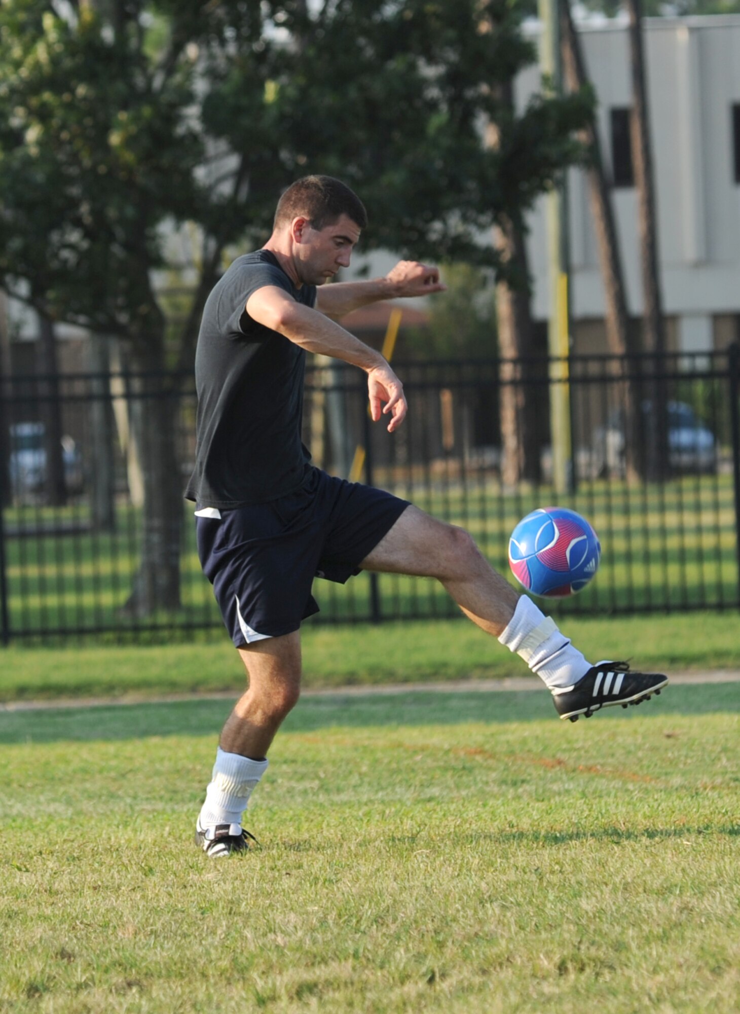 Adam Cross, 85th Engineering Installation Squadron, bumps the ball with his leg as it is passed to him by a teammate during an intramural soccer game against the 334th Training Squadron August 7, 2012, at Keesler Air Force Base, Miss.  The Gators defeated the 85th 6-2.  (U.S. Air Force photo by Kemberly Groue)