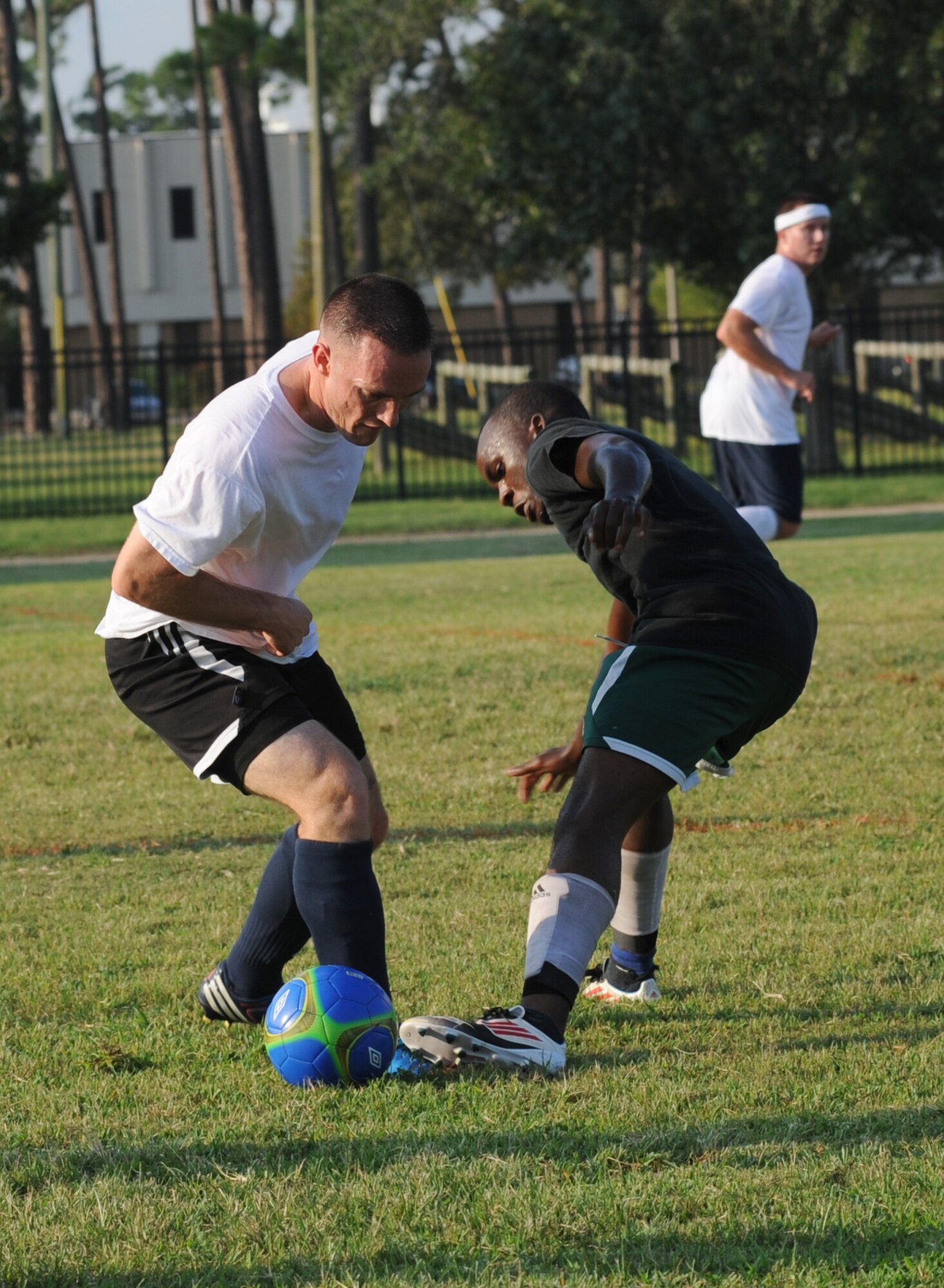 Eric Hagan, 334th Training Squadron, and Rajab Kigembe, 85th Engineering Installation Squadron, battle for the ball during an intramural soccer game August 7, 2012, at Keesler Air Force Base, Miss.  The Gators defeated the 85th 6-2.  (U.S. Air Force photo by Kemberly Groue)