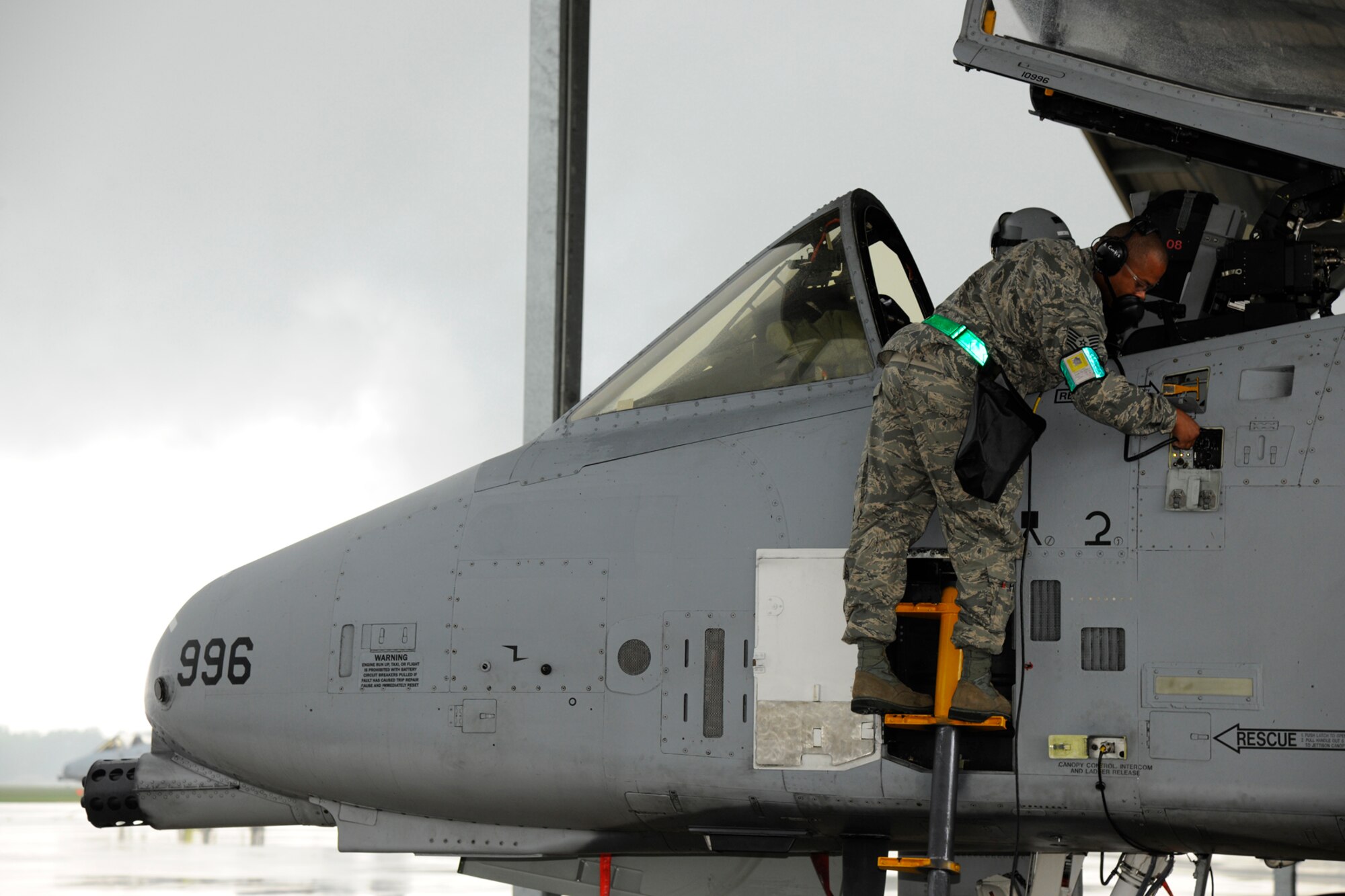 TSgt Ashane Curtis from the 127th Aircraft Maintenance Squadron connects to a communications system on an A-10 Thunderbolt II prior to at Selfridge Air National Guard Base, Mich., Aug. 10, 2012.  Communications between the pilot and maintenance crew are vital during launch, recovery and turning of the aircraft.  (Air National Guard photo by TSgt. David Kujawa)