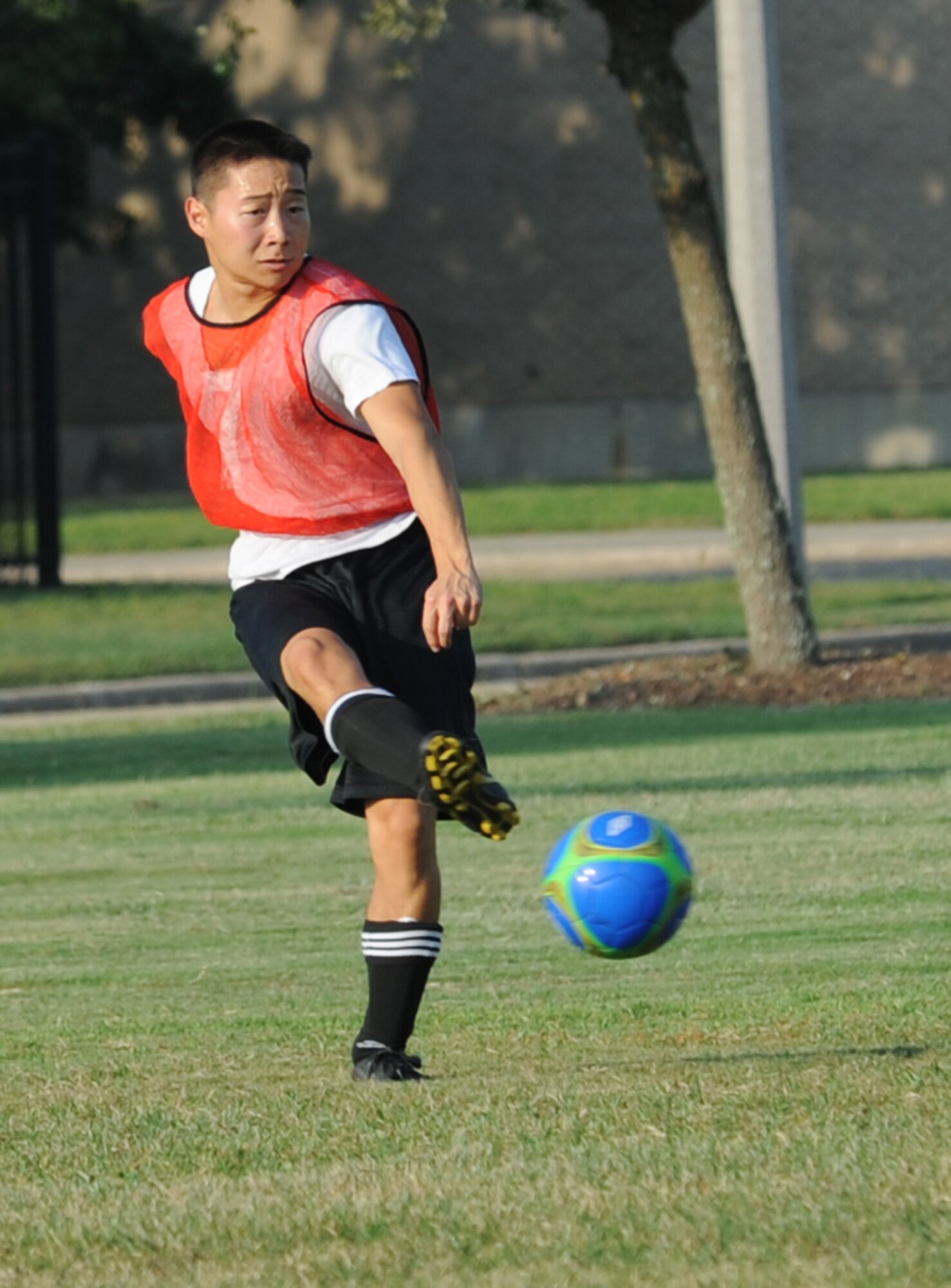 Kevin Atebara, 85th Engineering Installation Squadron, passes the soccer ball to a teammate during an intramural soccer game against the 334th Training Squadron August 7, 2012, at Keesler Air Force Base, Miss.  The Gators defeated the 85th 6-2.  (U.S. Air Force photo by Kemberly Groue)