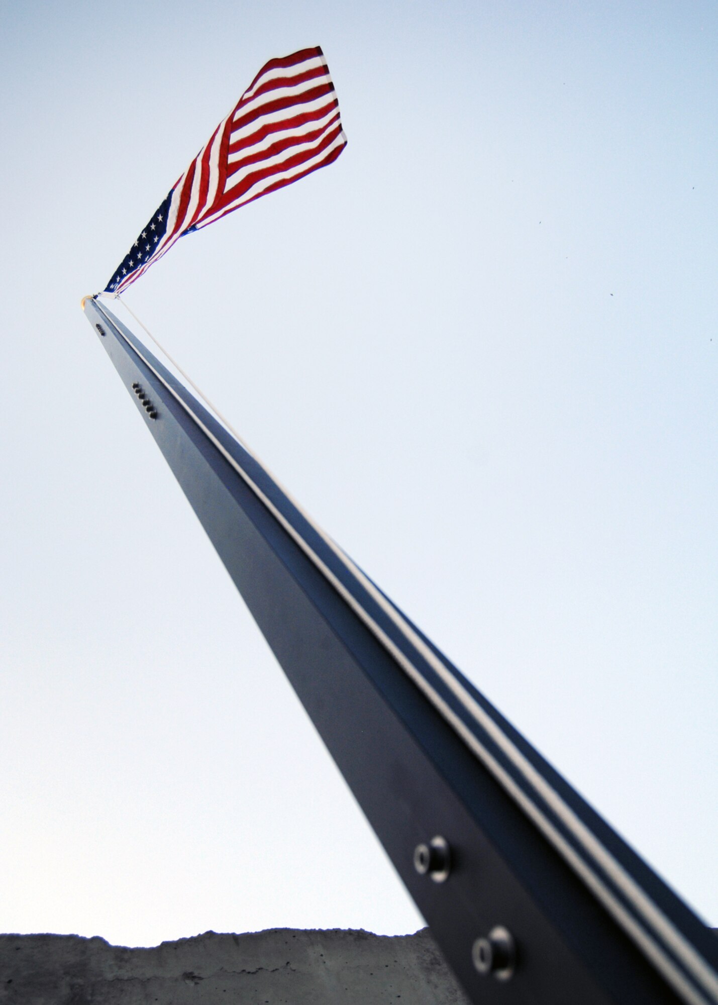 The U.S. flag flies high above the contingency aeromedical staging facility at Kandahar Airfield, Affghanistan,  Aug. 4, 2012. The CASF is responsible for transporting patients in and out of Kandahar Airfield who are injured or wounded from a forward operating base, combat outpost or even more remote locations. (U.S. Air Force photo/Master Sgt. Russell Martin)
